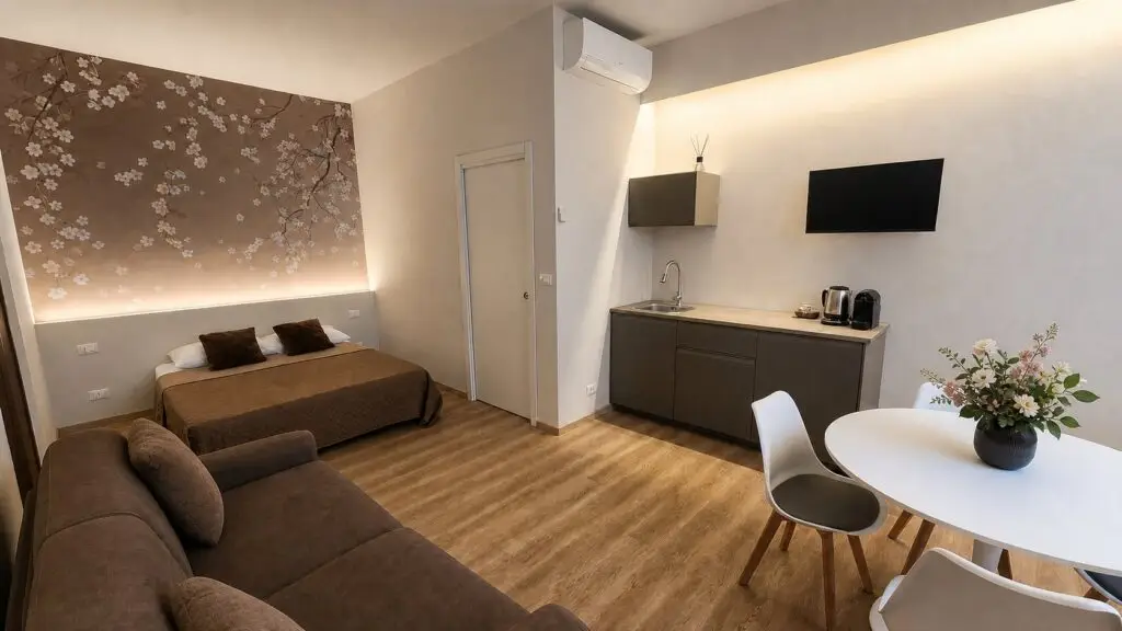 Room 1 at Gaia Suites in Turin with a double bed, sofa bed and refreshment area
